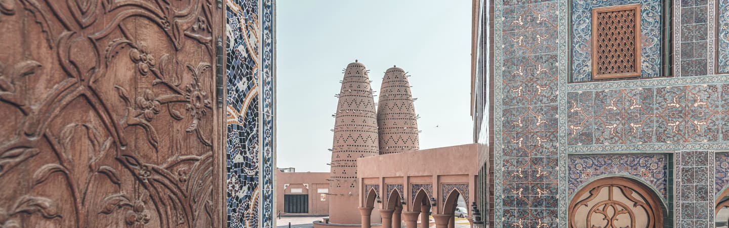 A Doha building framed through a stone doorway.