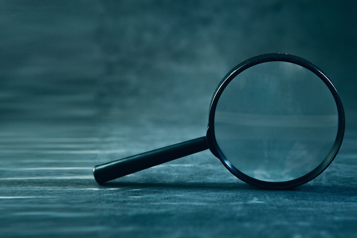 Magnifying glass on a dark background symbolizing a tracking and CAPI audit that checks whether reported conversion data is actually accurate
